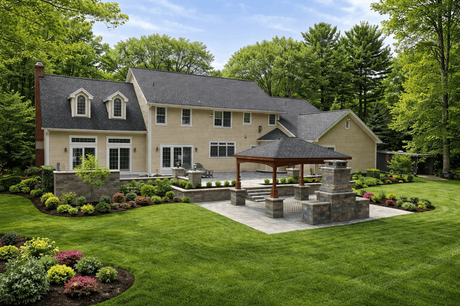 Spacious backyard with a pavilion, fire pit, and beautifully landscaped garden area.