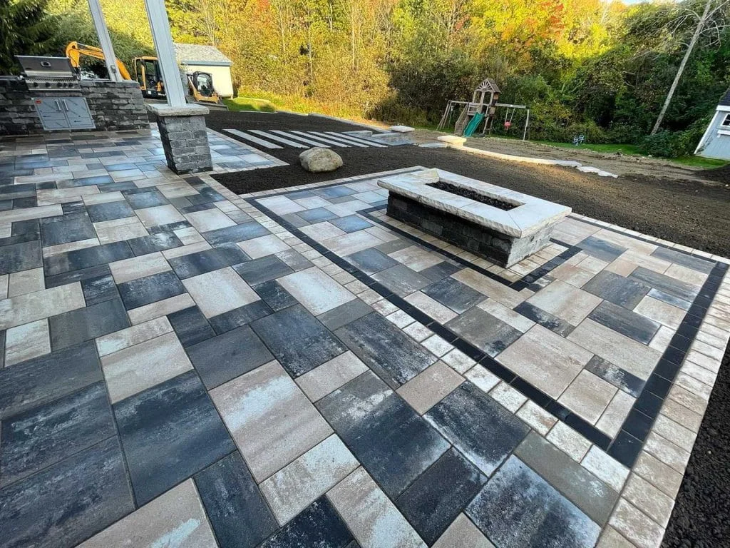 Modern paver patio with geometric pattern and built-in rectangular fire pit
